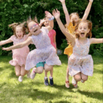 Girls at camp jumping and having fun